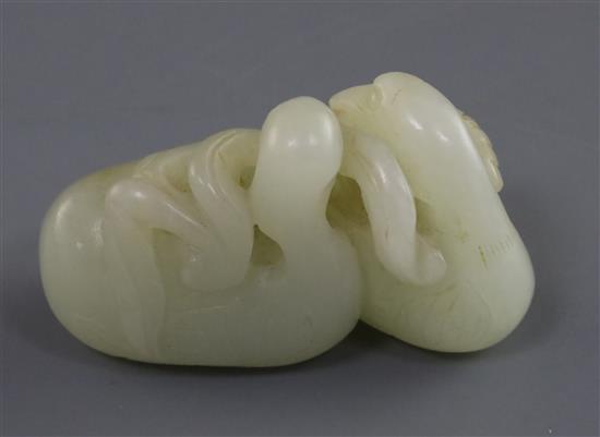 A Chinese pale celadon jade carving of two ducks biting lotus, 19th century L. 5.3cm